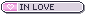 a small grey button with a small pink heart over a pink background to the left and text to the right that says in all caps in love